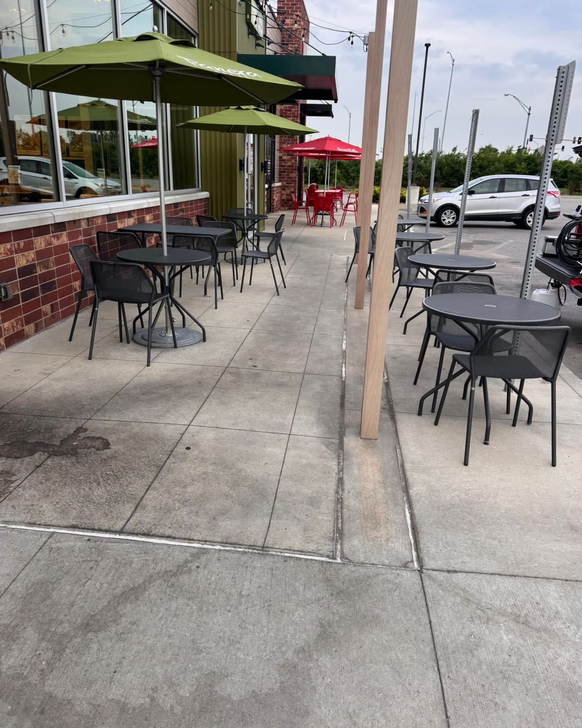 Dirty concrete walkway and patio seating before cleaning