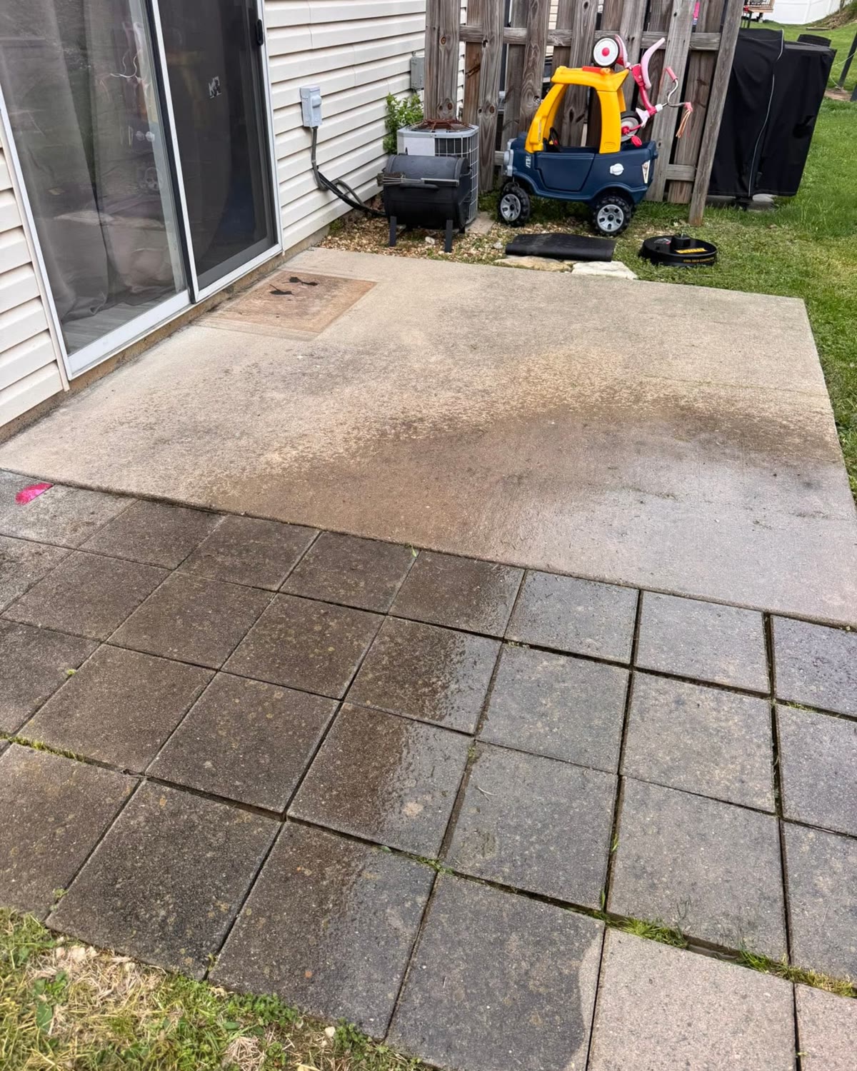 Stained concrete patio and pavers before cleaning